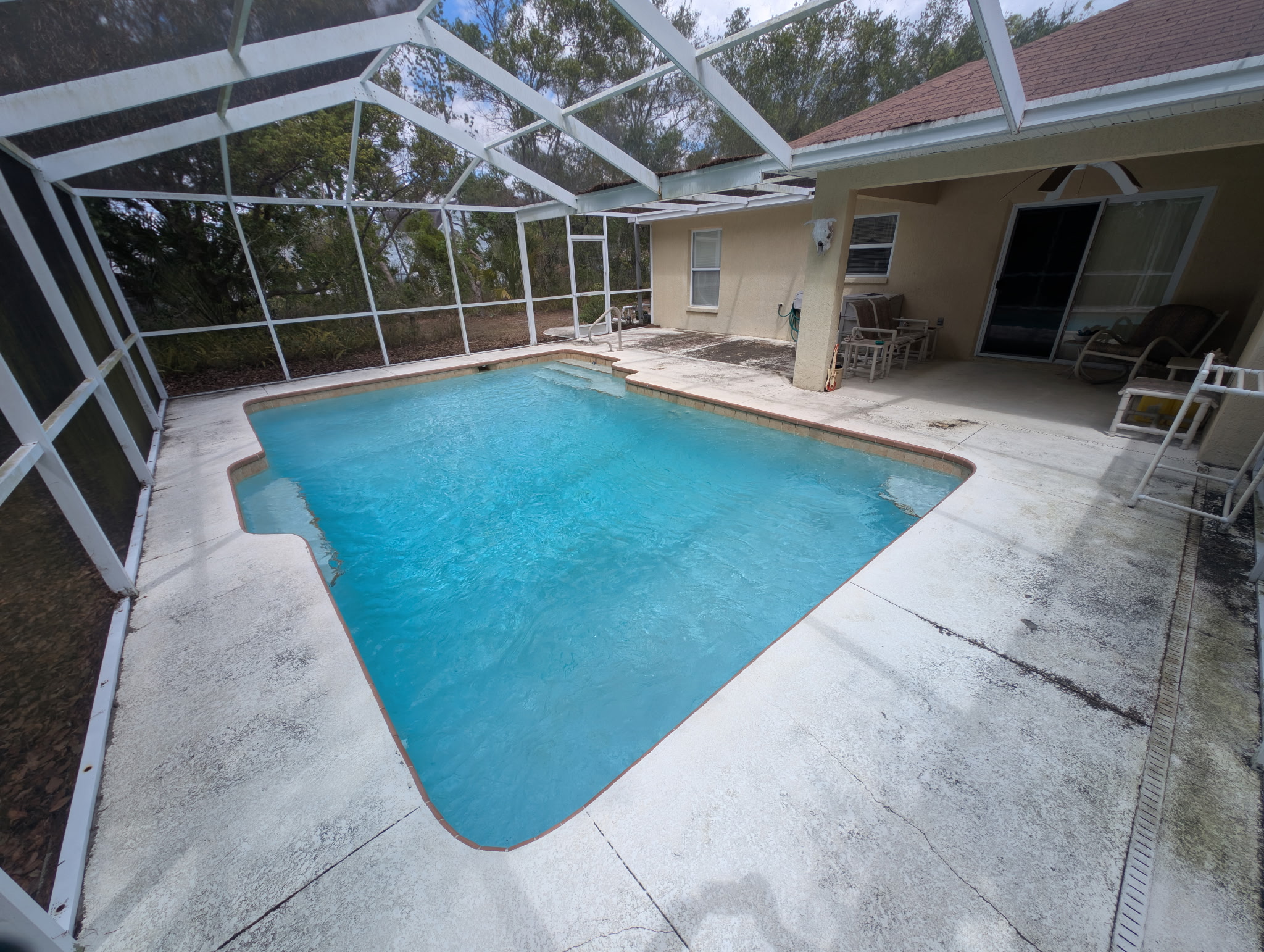Pool patio before cleaning — dull and dirty