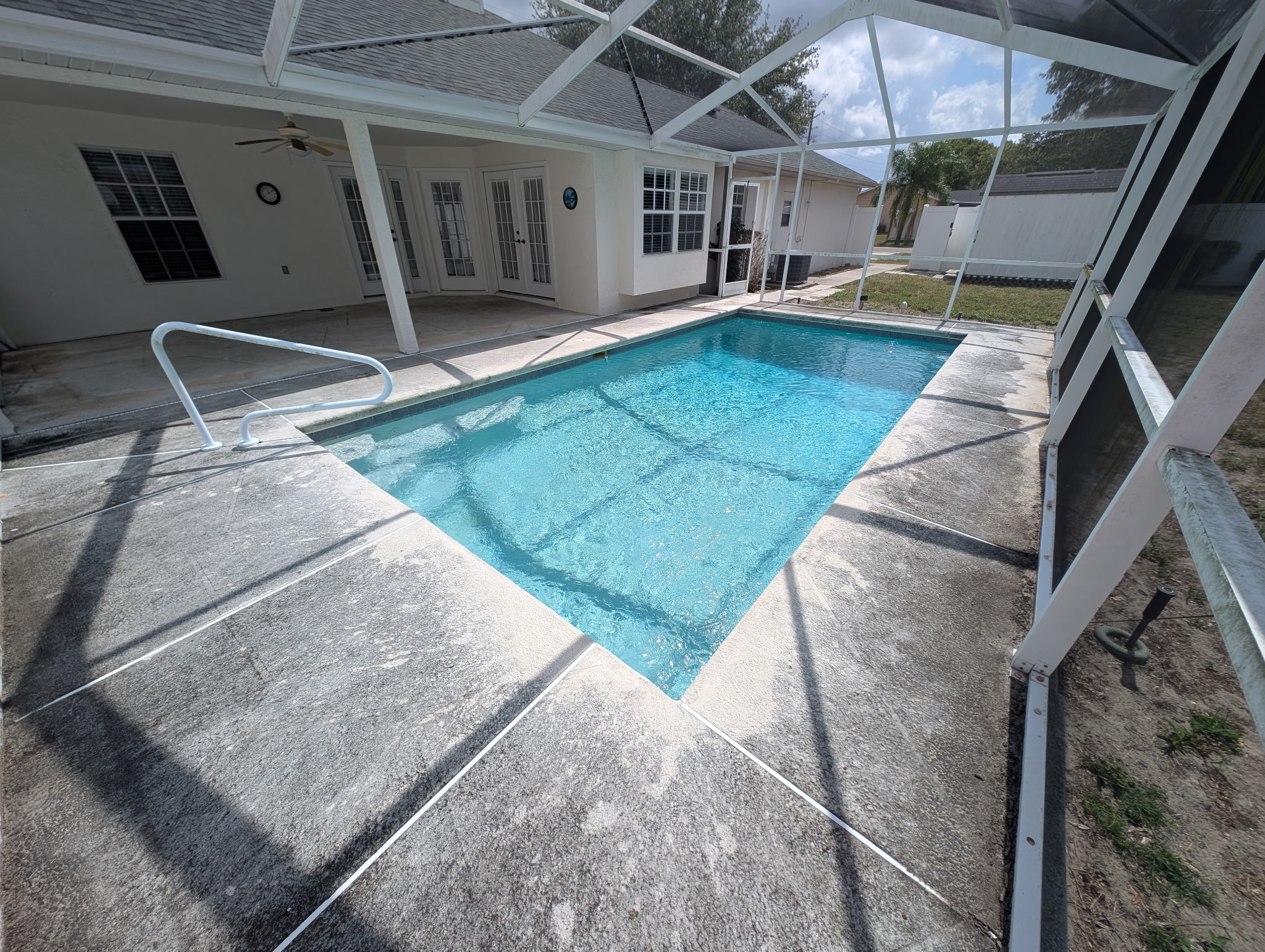 Pool deck before cleaning — dirty, stained concrete
